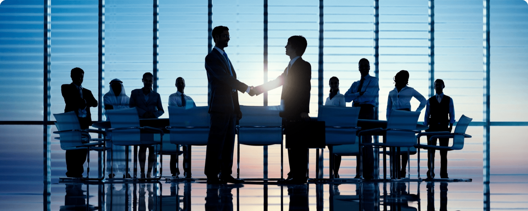 two-businessmen-having-together-with-theri-colleagues@2x
